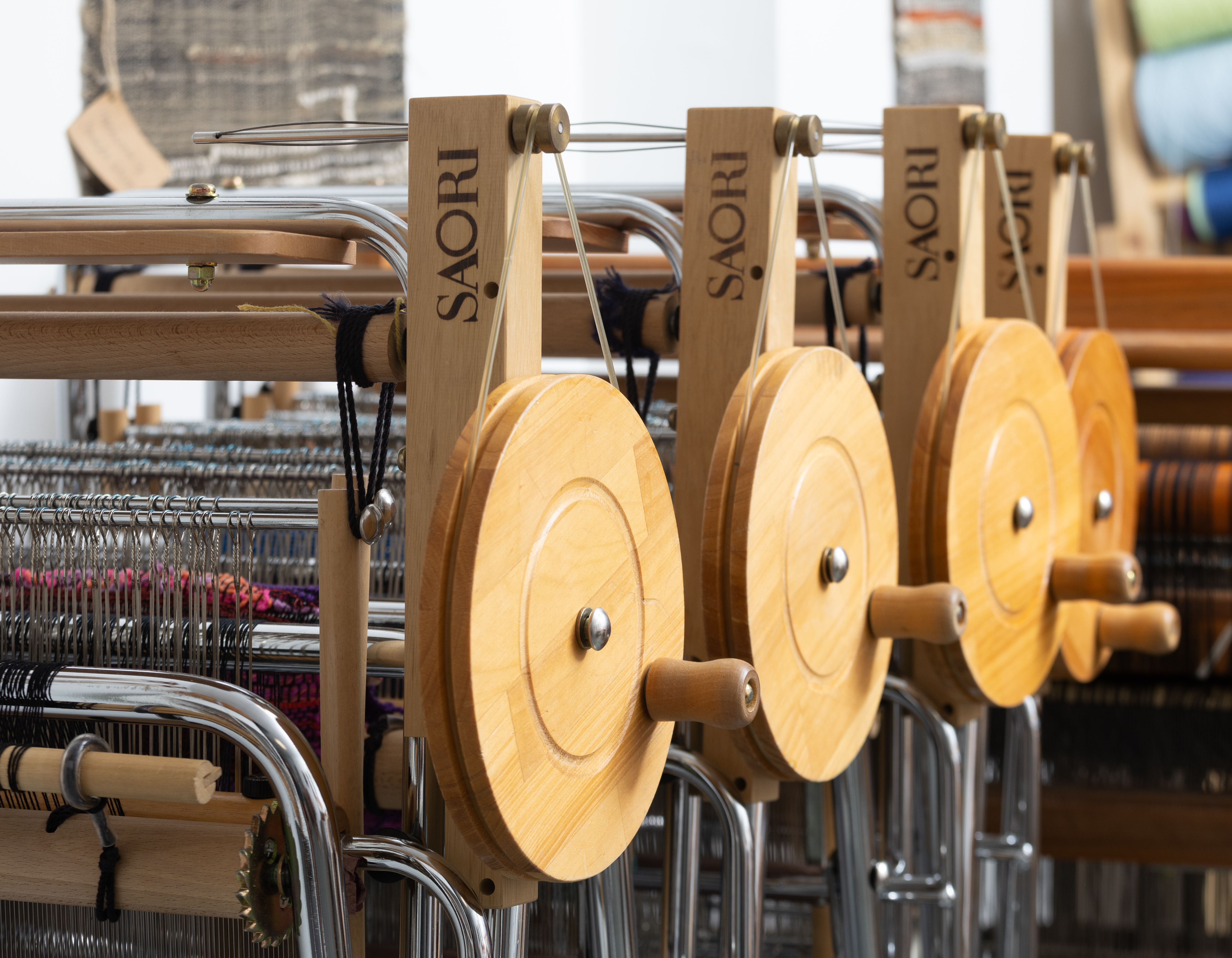 A photographs of various Saori Looms